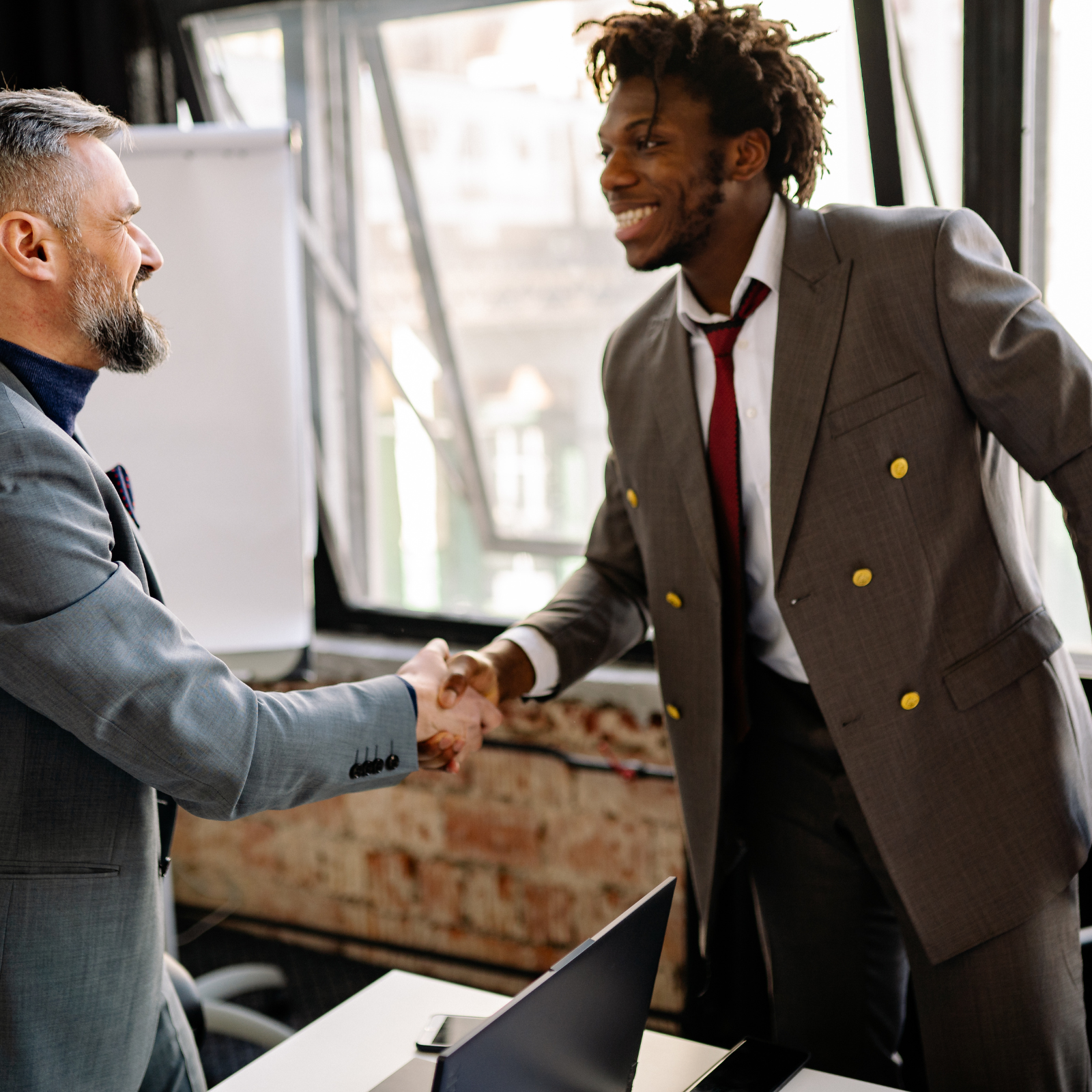Two professionals shaking hands after agreeing a recovery mandate